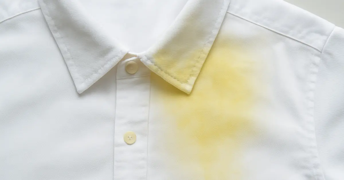 Close-up of a white shirt with yellow stains on the collar and underarms
